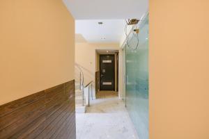 a hallway of a house with a black door at FabHotel Posh Classic in Gurgaon