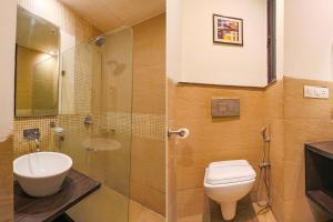 a bathroom with a toilet and a sink and a shower at FabHotel Posh Classic in Gurgaon