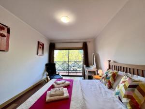 a bedroom with a bed and a window at Albufeira Modern 4 With Pool by Homing in Albufeira +21 photos