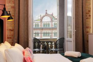 a room with a bed and a view of a building at Giselle Vintage Doubles - Adults Only in Budapest