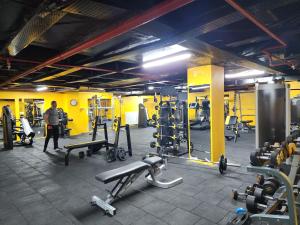 a gym with lots of equipment and a man standing in it at Luxury apartment in Istanbul in Istanbul
