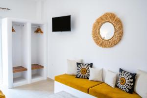 - un salon avec un canapé et un miroir dans l'établissement Anemos Guest Apts, à Karpathos