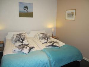 Hotell Turistgården i Simrishamn في سيمريسهامن: غرفة نوم عليها سرير ووسادتين