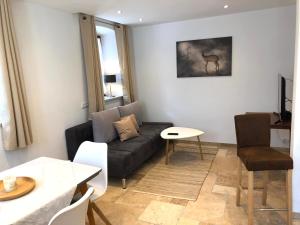 a living room with a couch and a table at Ferienwohnung 3 Rinser in Vogtareuth