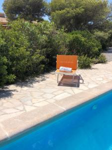 a chair sitting next to a swimming pool at CASA VALENTINA VIVIENDA TURISTICA ET6135 in Es Calo