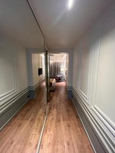 an empty room with a hallway with a mirror at Hotel Poonja International in Mangalore