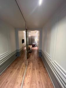 an empty room with a hallway with a mirror at Hotel Poonja International in Mangalore