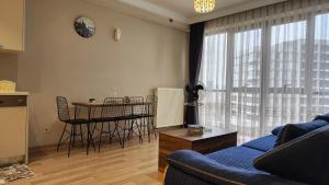 a living room with a blue couch and a table at Luxury apartment in Istanbul in Istanbul