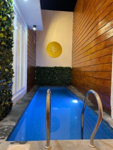 a swimming pool in a house with a swimming pool at The Glory Villas in Batu