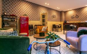 a living room with couches and a red refrigerator at The Newport Lodge - incl Breakfast, 3u Wellness and Ebike in Nieuwpoort