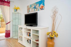 a living room with a tv on a white cabinet at Alborada Golf 3 1A Spaniahome in Albir