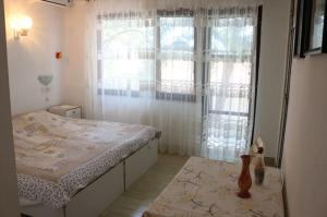 a bedroom with a bed and a large window at Apartmani Diego in Sveta Nedelja