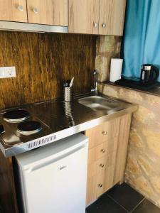 a small kitchen with a sink and a stove at Kimiro Drosia Zante in Psarou