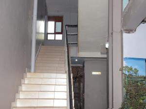 Una escalera que conduce a un edificio con ventana en CS HOTEL, en Hoima
