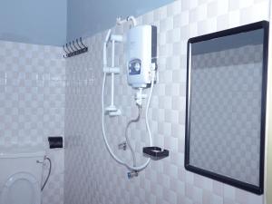 a shower in a bathroom with a mirror at CS HOTEL in Hoima