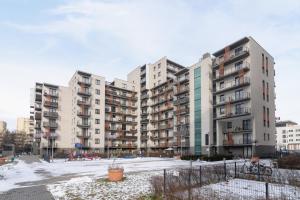 a group of apartment buildings in a parking lot at Dobrego Pasterza Studio with Balcony Cracow by Renters in Krakow