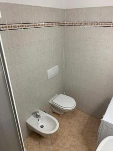 a bathroom with a toilet and a sink at Barzio Centro 08 in Barzio