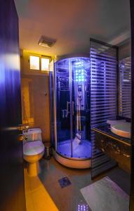 a bathroom with a shower and a toilet and a sink at Rose Oasis Hotel in Najran