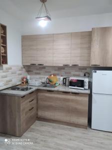 a kitchen with a white refrigerator and a microwave at ГудиВуди in Tsaghkadzor
