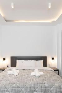 a bedroom with a large bed with two pillows on it at Lux studio at French Institute in Thessaloniki