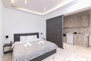 a bedroom with a large bed and a kitchen at Lux studio at French Institute in Thessaloniki
