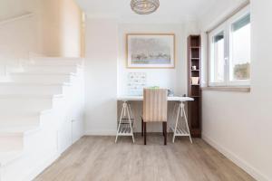 a dining room with a table and a desk at Cascais Center 3 bdr - Family Haven in Cascais +14 photos