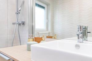 a bathroom with a white sink and a shower at Cascais Center 3 bdr - Family Haven in Cascais