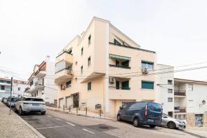 a building with cars parked in front of it at Cascais Center 3 bdr - Family Haven in Cascais