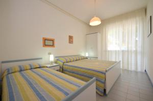 En eller flere senge i et værelse på Appartamenti Antares