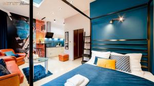 a bedroom with a bed with a blue headboard at Wonder Home - Apartamenty w przyziemiu z widokiem na Śnieżkę - cicha okolica in Karpacz