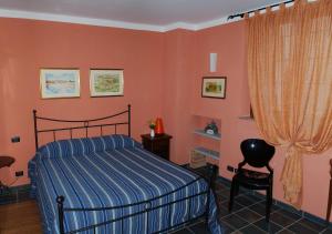 a bedroom with a bed and orange walls at L'Angolo di Rosina in Novello