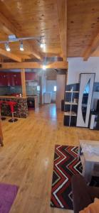 a large room with wooden ceilings and a wooden floor at Apartman DANE in Štikada +20 photos