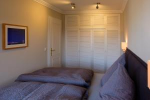 a bedroom with a bed in front of a window at Sola Bona 24 in Westerland