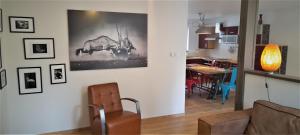 a living room with a couch and a dining room at Au Marronnier in Lontzen