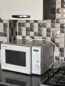 a microwave oven sitting on a counter in a kitchen at nice little apartment with swimming pool in Agadir