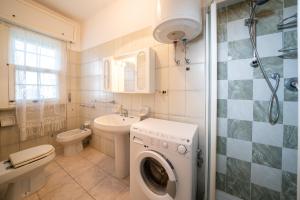a bathroom with a washing machine and a sink at Green Marine in Silvi Marina +113 photos