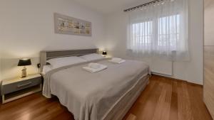 En eller flere senge i et værelse på Four Seasons Apartment - FREE PARKING