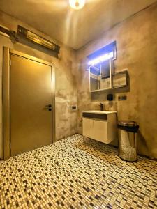 baño con lavabo, espejo y puerta en Nomad Hostel Karaköy en Estambul
