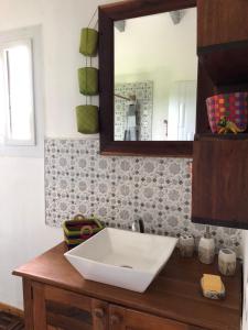 y baño con lavabo y espejo. en Maison madasgascar, en Ampasikely