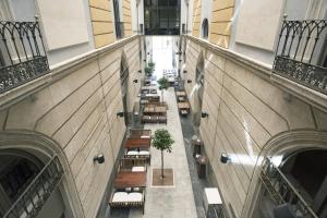 an overhead view of a building with tables and benches at Hospes Amérigo, Alicante, a Member of Design Hotels in Alicante