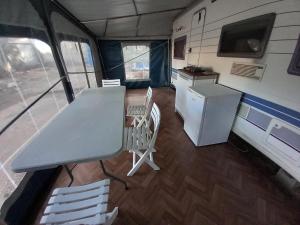 a table and chairs in a kitchen in an rv at Caravan near the sea 6 in Ugljan