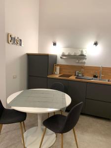 a kitchen with a table and chairs and a counter at apartment rent Casa ALMIKA in Bari