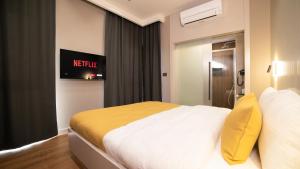 A bed or beds in a room at Vesta Rooms
