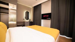 A bed or beds in a room at Vesta Rooms