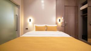 A bed or beds in a room at Vesta Rooms