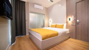 A bed or beds in a room at Vesta Rooms