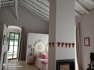a bedroom with a bed and a fireplace at Finca La Favorita in Constantina