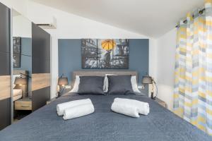 a bedroom with a bed with two white pillows at wine house apartments& rooms Marčeta in Fažana