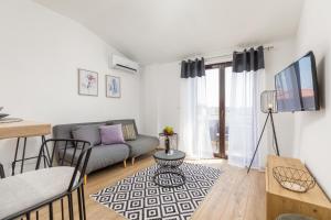 a living room with a couch and a table at wine house apartments& rooms Marčeta in Fažana