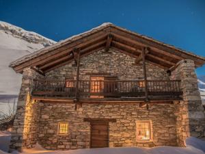a stone house with a balcony on top of it at Chalet Val-d'Isère, 6 pièces, 12 personnes - FR-1-519-32 in Val-d'Isère